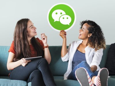 Young women showing a WeChat icon